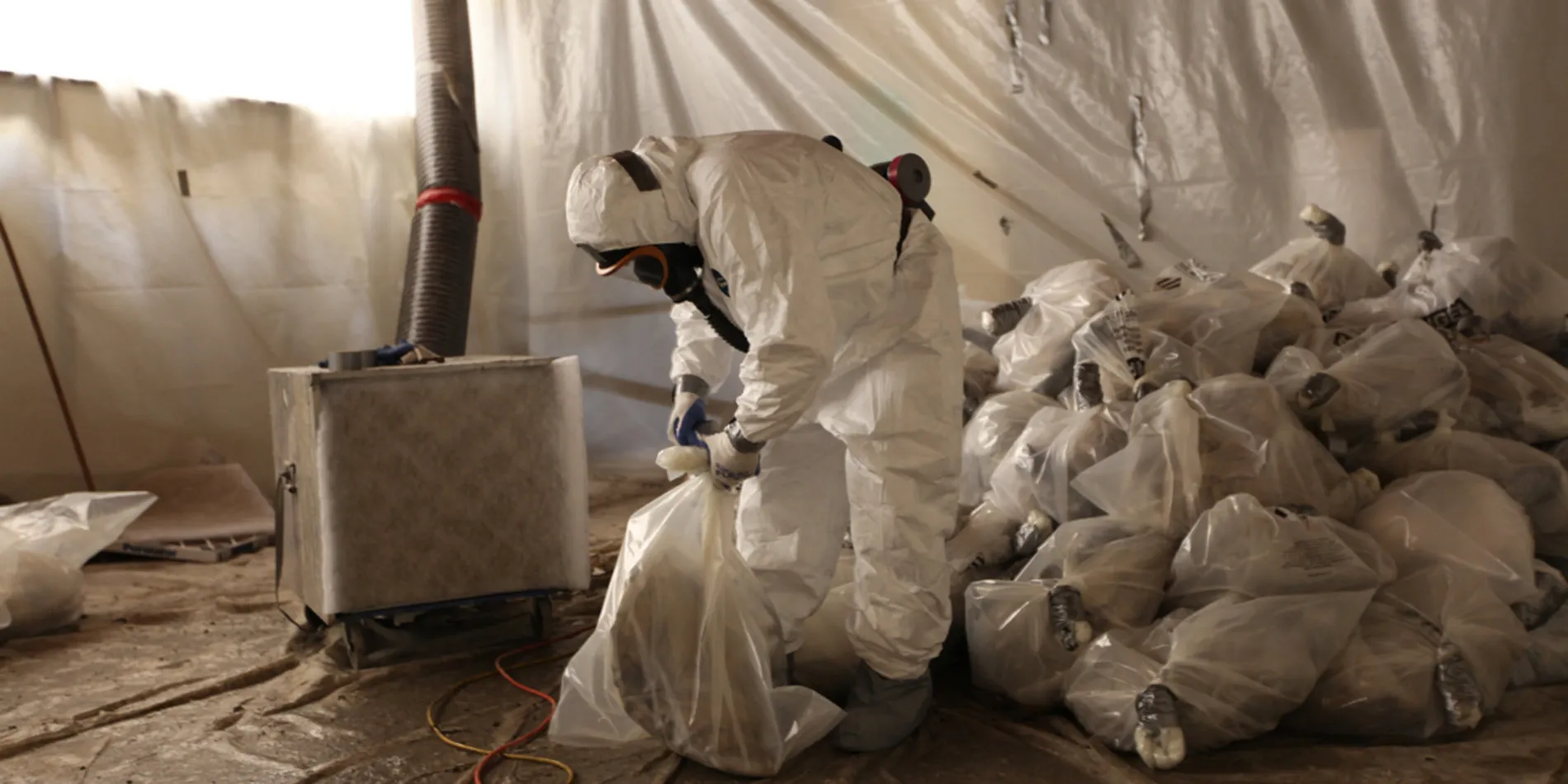 Protective worker performing asbestos abatement service
