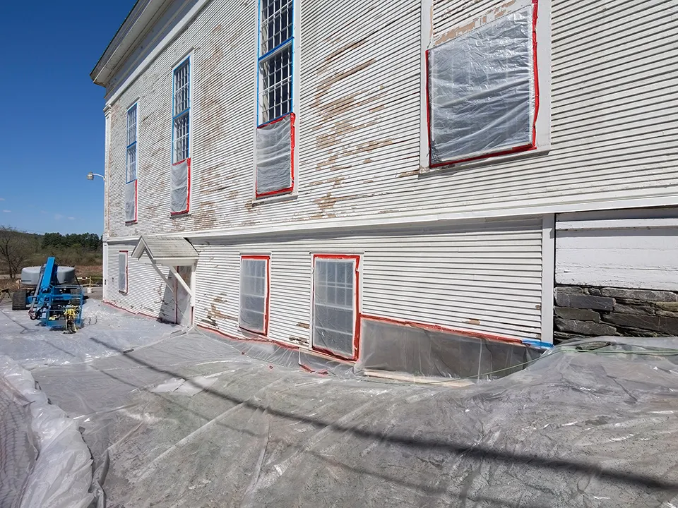 Technician conducting lead paint removal in an old building